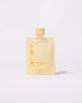 Front view of a yellow pouch of BOUNCE.ME Curl Shampoo discovery size 60ml