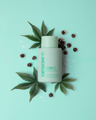 GLOSS.ME Hydrating Shampoo bottle surrounded by hemp leaves and seeds, highlighting key natural ingredients.