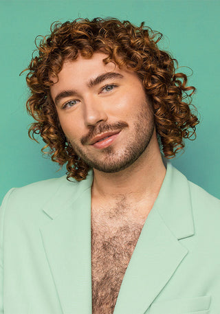 Male model with healthy, shiny hair, showcasing smooth, hydrated 2c curly hair.