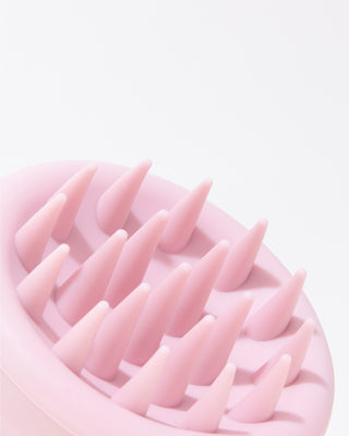 Close-up of DESIGNME scalp brush soft flexible bristles for gentle scalp massage.