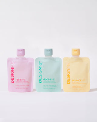 Front view of three pouches of DESIGNME shampoo bundle 60ml with different colors on the caps, indicating three different variants: BOUNCE.ME, GLOSS.ME & PUFF.ME