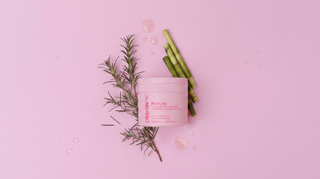 PUFF.ME Volumizing treatment whip 250ml on top of rosemary and bamboo & a pink background