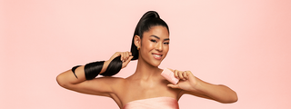 Model with a long, sleek ponytail holding HOLD.ME Styling Stick in one hand.