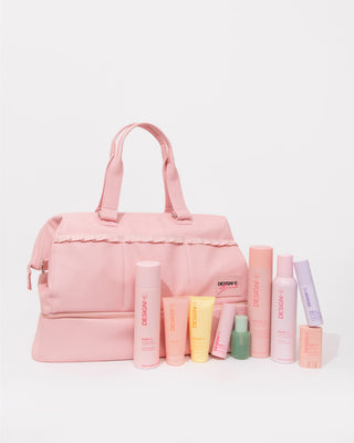 Ally Nicole x DESIGNME Travel Beauty Bag with the stylist bundle products sitting in front of the bag.