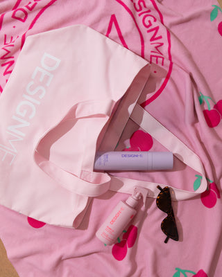 DESIGNME limited-edition Beach Bundle products laid out on a beach.