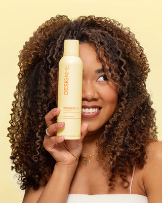 A model holding up BOUNCE.ME curl mousse