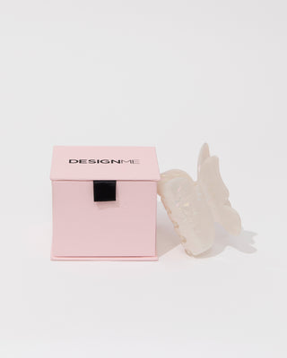 DESIGNME exclusive butterfly hair clip and pink box on white background.