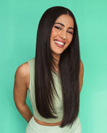 Smiling model with glossy, smooth hair, showcasing the results of deep hydration.