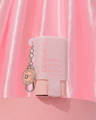 HOLD.ME styling stick glitter pouch with a pink background.