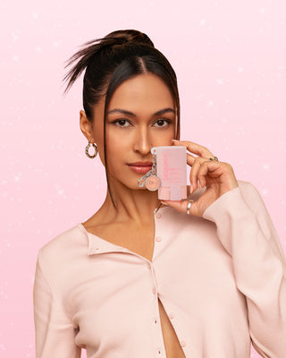 Model holding HOLD.ME styling stick glitter pouch