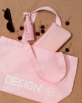 Limited edition tote bag laying on the beach with PUFF.ME sea salt spray & water resistant beach pouch inside.