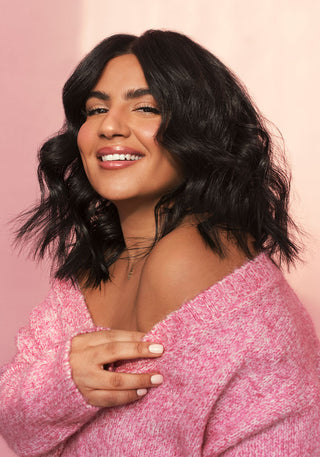 Photo of a model with gorgeous, short, bouncy hair showing off volume and shine after using the PUFF.ME Volumizing Wash Day Bundle.
